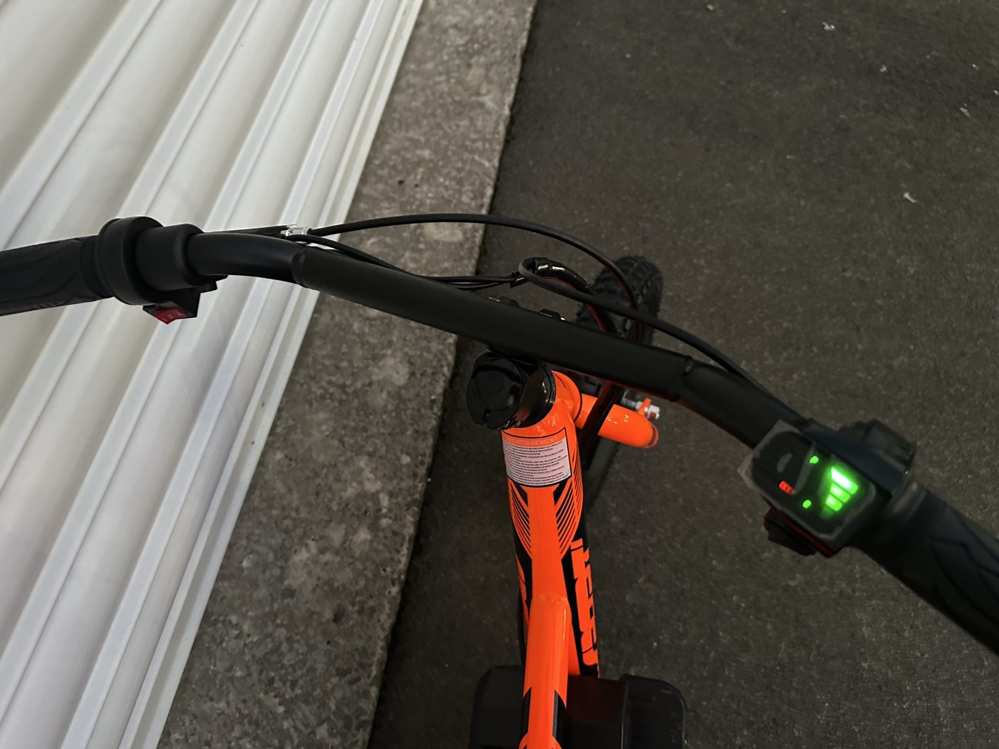 AB Bikes Kids Bikes 12 electric bikes in orange – handbar view