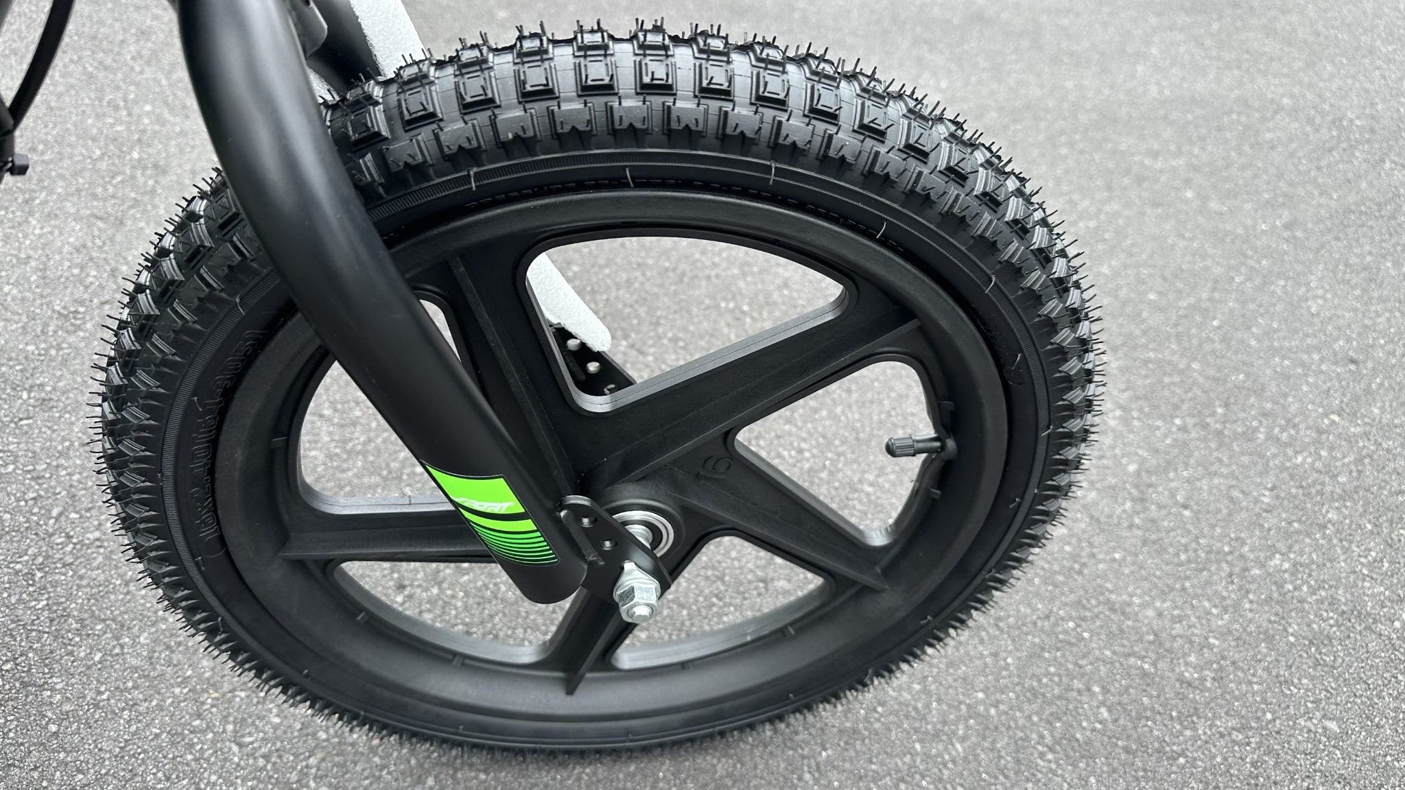 AB Bikes Kids Bikes 16 electric balance bike in green and black – front wheel view