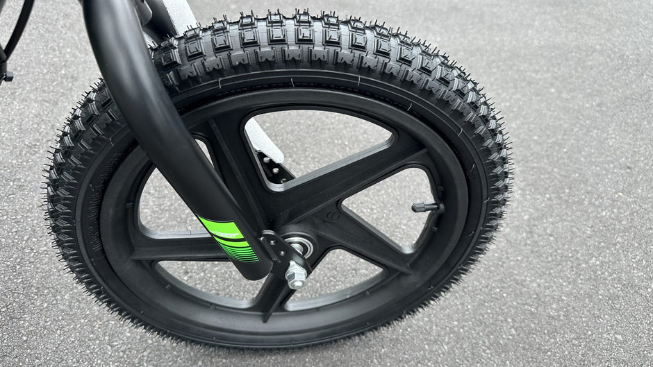 AB Bikes Kids Bikes 16 electric balance bike in green and black – front wheel view