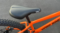 AB Bikes Kids Bikes Wrap Mountain bike in orange – bike seat view
