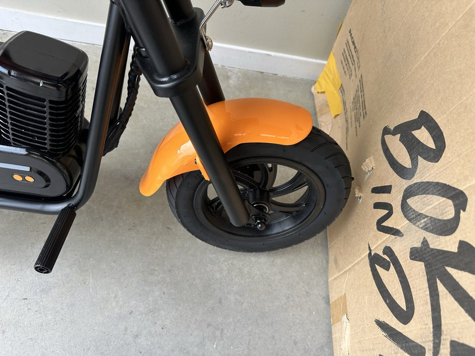 AB Bikes Kid Bike Electric Kids Bike in orange – front wheel view